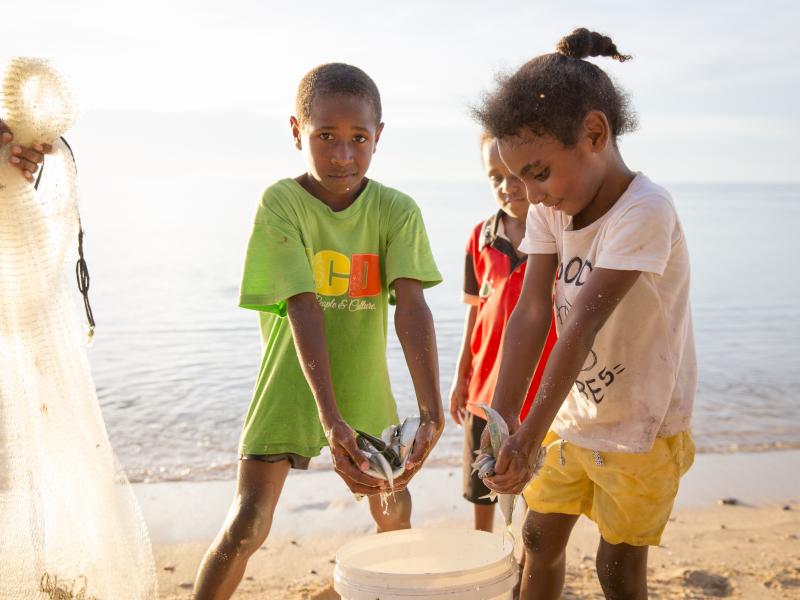 Children with a bucket of caught fish